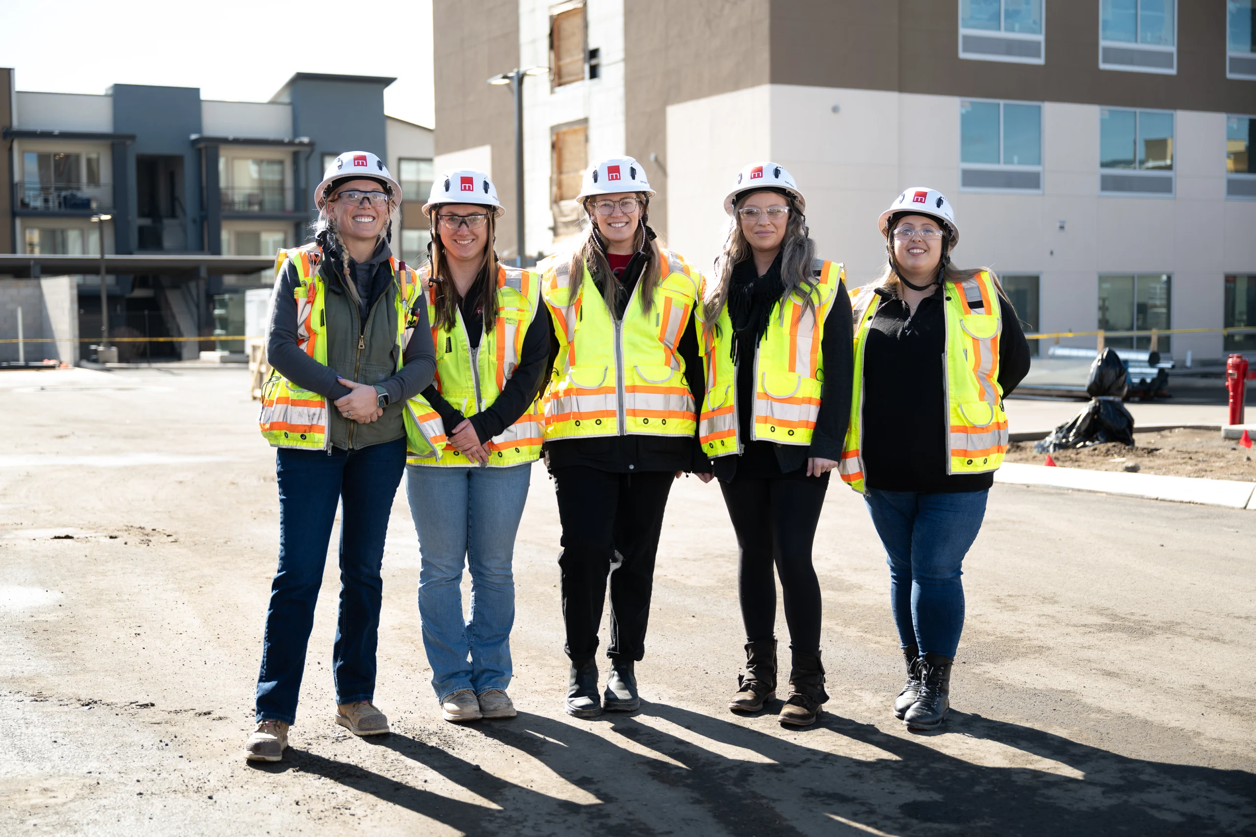 Photo of women in construction with hardhats